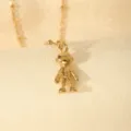Gold-tone robot pendant necklace detail shot, elegant minimalist metal jewelry accessory. - Blohsh Person