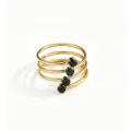 Detailed close-up of a multi-loop spiral gold ring featuring sparkling black zirconia stones. - Black Multi-layer