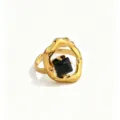 Close-up detail of the irregular molten gold ring featuring a central square black zircon. - Black Square