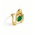 Close-up detail of the elegant gold open ring featuring a sparkling green marquise zircon. - Green Marquise