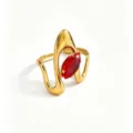 Detail shot of a stylish gold-tone stainless steel ring featuring an eye-catching red marquise zircon stone. - Red Marquise