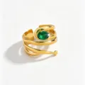 Detailed shot of a luxury 18k gold plated stainless steel spiral ring with green zircon. - Open Adjustable / Green