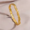 Golden stainless steel twisted bangle detail shot, elegant open cuff design with texture. - Twisted Texture Knot