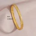 Elegant gold plated stainless steel open bangle featuring textured mesh and cross motifs. - Grid Cross Embossed
