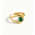 Close-up detail of the 18k gold plated stainless steel ring featuring a sparkling green zircon. - Open Adjustable / Green