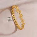Gold plated stainless steel bow link open bracelet, fashion jewelry detail view for women. - Bow Chain Splice