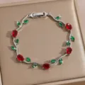 Detailed shot of a luxury zircon flower bracelet with red and green stones on silver chain. - DQ-W-4093-3