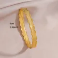 Gold plated stainless steel open bangle bracelet with wavy geometric design for women detail view. - Geometric Diamond Grid Wave