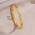 Close-up view of a gold-plated diamond lattice patterned bangle bracelet with elegant wavy edges. - Diamond Grid Wave