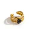 Gold stainless steel open ring detail view, featuring a sleek black stone and ribbed band. - Vertical Stripe Oval Style (DQ-W-3440-4)