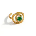 Gold plated stainless steel snake ring detail with green zircon gemstone sparkle close up - Twisted Snake Oval Style (DQ-W-3443-1)