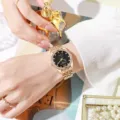 Elegant gold-tone ladies' quartz watch with rhinestone-studded bezel and black dial - Black Dial Gold Case