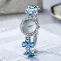 Detaillierte Nahaufnahme einer Armbanduhr mit Kleeblatt und blauen Herz-Kristallen - Blau