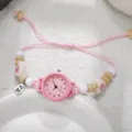 Detailed macro shot of a pink student quartz watch featuring a braided rope and bead strap - Number Pink (Bergkamp 8)