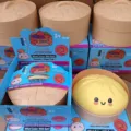 Giant 25cm simulation dumpling squishy toy with cute face and steamer box for stress relief. - Yellow