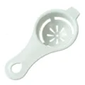 Light green wheat straw egg white separator tool with floral filter holes for baking. - Nordic Green