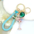 Detail view of metal rhinestone cocktail glass keychain with blue braided strap for backpack - Color 2 with Leather Strap