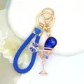 Detailed view of the blue braided leather strap keychain featuring a rhinestone cocktail glass. - Color 3 with Leather Strap