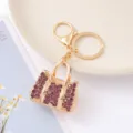 Modieuze strass handtas sleutelhanger, gouden metaal mini tas sleutelring hanger. - Fuchsia