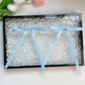 Light blue ribbon bow hair clips with long tails, elegant DIY hair accessories for holiday styling. - Blue