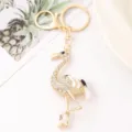 Exquisite rhinestone flamingo metal keychain pendant for cute car keys and designer bags. - White