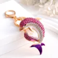 Dazzling rhinestone double dolphin keychain with gold tone finish and chic purple tail charm. - Dolphin 3