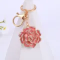 Detailed view of the exquisite pink enamel rose rhinestone keychain pendant, perfect accessory. - Pink