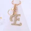 Rhinestone letter E keychain detail, gold alloy metal finish, sparkling crystal charm pendant. - Letter E
