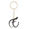 Gold letter keychain detail showcasing elegant black enamel script alphabet charm pendant. - Letter E
