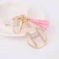 Fashion metal rhinestone letter H circular pendant keychain with pink leather tassel. - Letter H