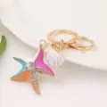 Closeup of vibrant enamel starfish and shell keychain with sparkling rhinestones and metal ring. - Starfish 1