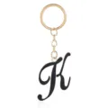 Gold metal keychain with black enamel letter K pendant detail, elegant bag charm accessory. - Letter K
