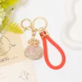 Detailed closeup of a luxury crystal lucky bag keychain with red braided leather strap. - Color 4 with Leather Rope