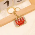 Exquisites Metall Strass Handtasche Schlüsselanhänger in Rot Emaille Design für Rucksack. - Rot