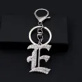 Close-up detail of the sparkling rhinestone Gothic letter E keychain, silver metal accessory. - Letter E