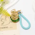 Chinese style cornucopia keychain with blue braided leather strap and green rhinestones. - Green with Leather Cord