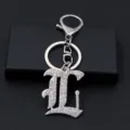 Detailed view of the silver metal rhinestone letter keychain, glittering diamond letter pendant charm. - L