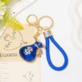 Porte-clés sac d'argent bleu avec lanière en cuir strass dollar détail anneau en métal. - Bleu Avec Corde Tressée