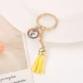 Gold metal tassel keychain with colorful rhinestone letter F charm for bag decoration. - Letter F