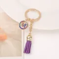 Metal rhinestone letter M keychain with purple tassel, stylish bag charm and keyring accessory. - M