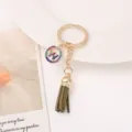 Close-up detail view of the elegant rhinestone letter tassel keychain and metal ring. - Letter W