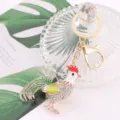 Close up of crystal rhinestone rooster keychain, metal zodiac chick pendant detail shot view. - Chicken 2