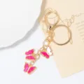 Porte-clés papillon en métal doré avec émail rose et strass étincelants, détail de charme de sac. - Rose Blanc