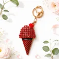 Rhinestone ice cream cone keyring detail shot with elegant gold hardware and red crystals. - Red