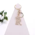 Gold rhinestone letter R crown keychain detail view showing sparkling crystal inlay. - Letter R