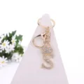 Gold rhinestone letter S keychain detail, sparkling crown charm for bags and keys. - Letter S