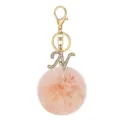 Detailed view of gold rhinestone letter N key chain with pink plush pom pom bag charm accessory. - Letter N