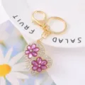 Gold tone metal heart keychain with rhinestone paved surface and purple crystal flower charms. - Color 4