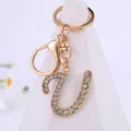 Detailed shot of gold alloy rhinestone letter keychain pendant, elegant sparkly accessory. - Letter U