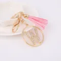 Gold metal rhinestone letter W keychain with pink tassel pendant for bag details view. - Letter W